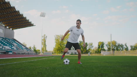 Skill-professional-soccer-player-a-man-runs-in-with-a-soccer-ball-on-a-soccer-field-in-a-stadium-demonstrating-excellent-dribbling-and-ball-control.